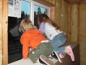 Gigi and Jude peeking out of Gigi's bedroom window.